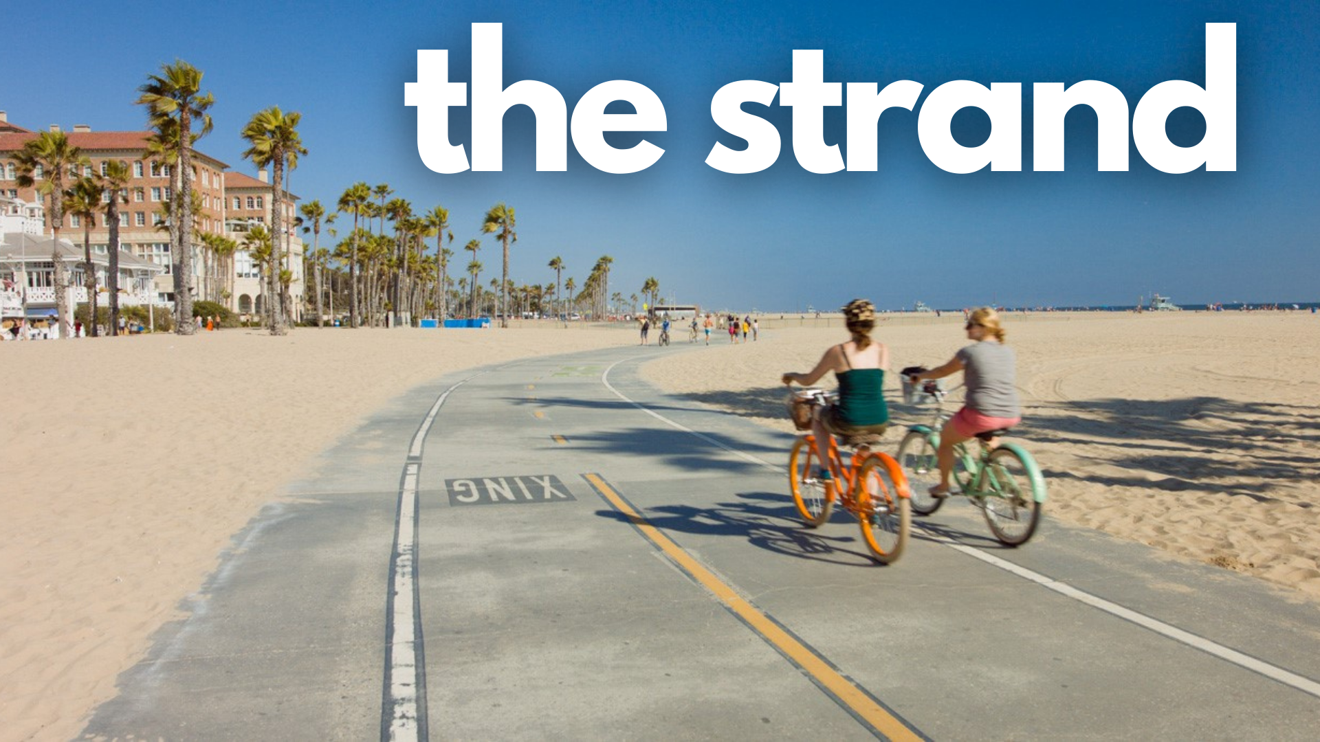 The Strand Bike Path - Santa Monica to Redondo Beach with two bikers on the path one that's orange and one that's green next to the beach with sand on both sides of the bike path